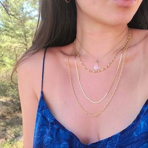 Layered gold necklaces with crystal